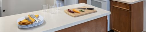 A kitchen with a white refrigerator, white stove, and brown cabinets.