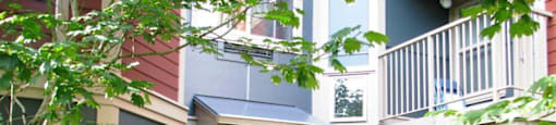 A building with a green bush in front of it.