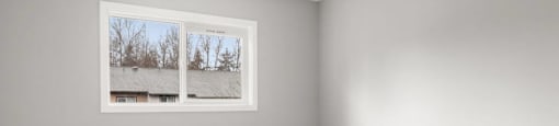 A room with a window showing a snowy landscape outside.