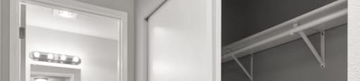 A white bathroom with a sink and mirror.