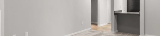A room with a striped carpet and a ceiling fan.
