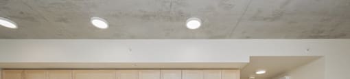 A kitchen with white appliances and wooden cabinets.