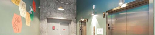 A hallway with a blue wall and a white door.