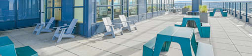 A modern outdoor seating area with blue and white furniture.