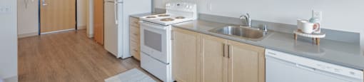 A kitchen with wooden cabinets and white appliances.