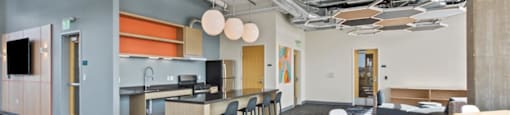 A modern office space with a long table and chairs.