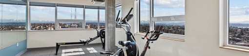 A room with a treadmill and a stationary bike.