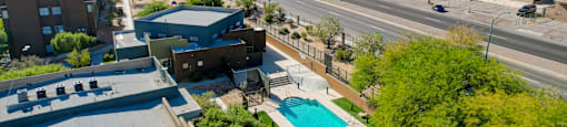 an aerial view of a parking lot with a pool and a city in the background at Maryland Villas Apartments, Nevada