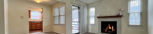 A spacious living room with a fireplace and a ceiling fan at Belmont Ridge Apartments, Monroeville, PA, 15146