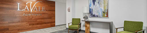 A conference room with a wooden wall and a carpeted floor.