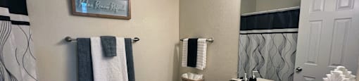 a bathroom with a sink and a toilet and a mirror at Belmont Ridge Apartments, Monroeville, PA, 15146
