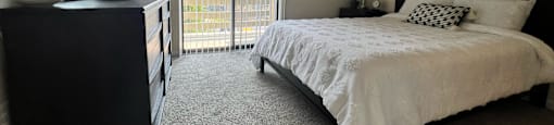 a bedroom with a large bed and a ceiling fan at Belmont Ridge Apartments, Monroeville, PA, 15146
