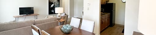 A dining room with a wooden table and chairs.