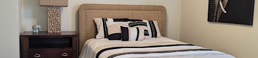 a bedroom with a bed and a ceiling fan