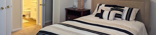 a bedroom with a bed and a ceiling fan