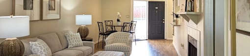 a living room with a couch and chairs and a fireplace