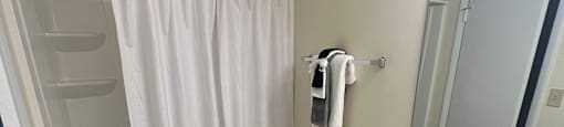 a bathroom with a toilet and a shower and a sink