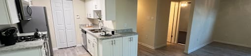 Open kitchen and living room with wood floors and white cabinets at Belmont Ridge Apartments, Monroeville, 15146