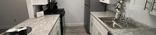 a kitchen with granite counter tops and stainless steel appliances at Lavale Apartments, Monroeville, Pennsylvania