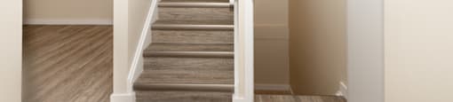 A staircase with wooden steps and white railings.