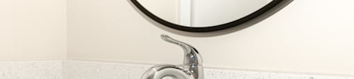 A modern bathroom sink with a chrome faucet.