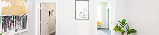 Winnipeg Apartments: a spacious living room with white walls and a white couch