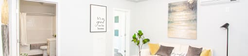 a living room with white walls and a white couch Winnipeg Rentals
