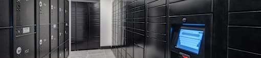 a row of black lockers with a screen in the middle