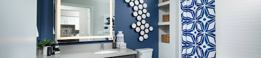 a bathroom with a blue and white shower curtain