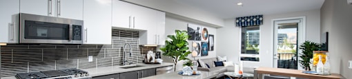 a kitchen with white cabinets and a large island with a white countertop
