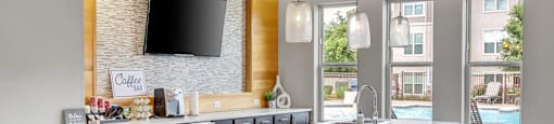 a kitchen with a large island and a tv on the wall