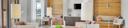 a living room with couches and chairs