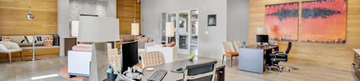 a large office with a desk with a computer and chairs