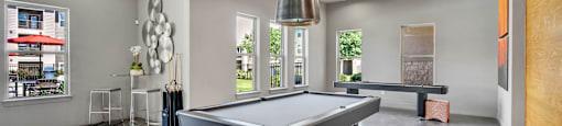 a game room with a pool table and a ping pong