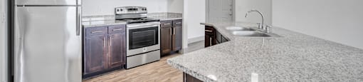 a kitchen with stainless steel appliances and a granite counter top