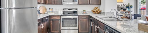 a kitchen with wooden cabinets and stainless steel appliances