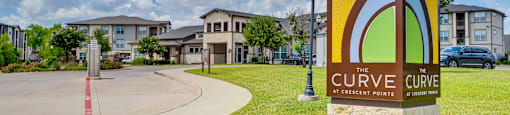 the cure care sign in front of apartments