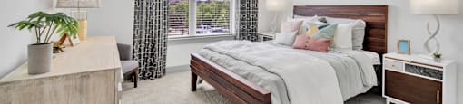 a bedroom with a bed and a ceiling fan