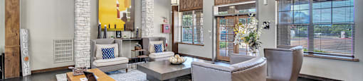 a living room with couches and chairs and a table