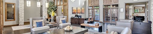 a living room with couches and chairs and a table