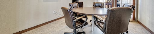 a conference room with a table and chairs and a window