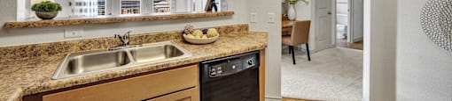 a kitchen with a sink and a window and a dining room