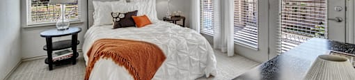 a bedroom with a large bed and a ceiling fan