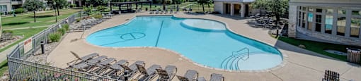 the preserve at ballantyne commons pool with chairs and apartment buildings