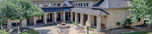 the backyard of a house with a patio and table and chairs