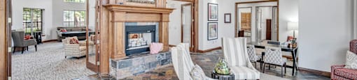 a large living room with a fireplace and furniture