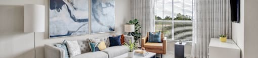 a living room with couches and chairs and a coffee table