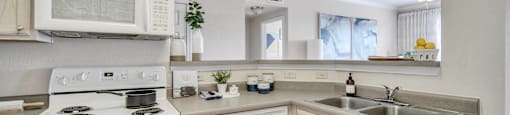 a kitchen with white appliances and wooden cabinets