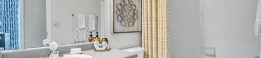 a bathroom with a shower curtain and a toilet and a sink