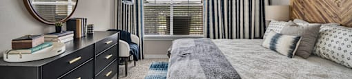 a bedroom with a large bed and a ceiling fan